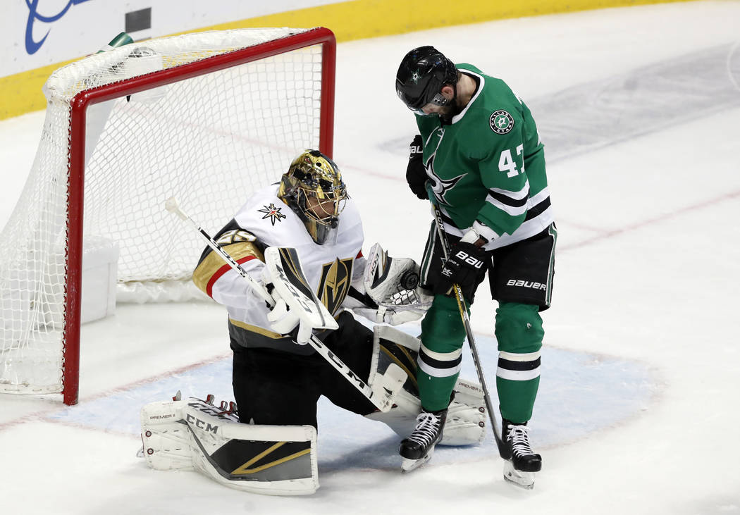 Vegas Golden Knights goaltender Marc-Andre Fleury (29) gloves a shot under pressure from Dallas Stars right wing Alexander Radulov (47) in the third period of an NHL hockey game in Dallas, Friday, ...
