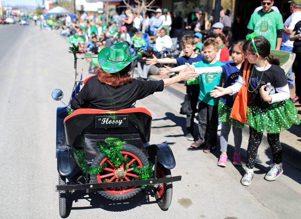 Cheri Delarosa, with the Ladies Oriental Shrine of North America Zel-Neva Court 96, gives out high fives in the 53rd Annual Southern Nevada Sons & Daughters of Erin St. Patrick's Day parade in ...
