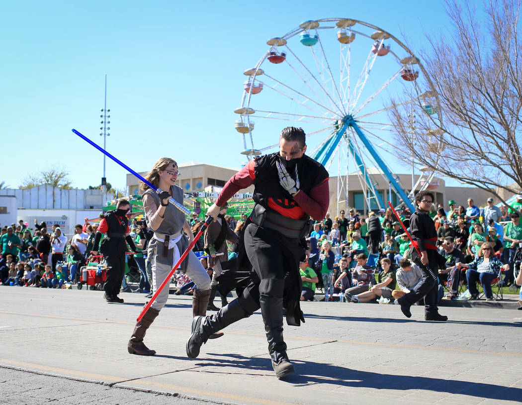 Two members of the Society of Light-saber Duelists UNLV chapter break into a fight during the 53rd Annual Southern Nevada Sons & Daughters of Erin St. Patrick's Day parade in Henderson, Nev., ...