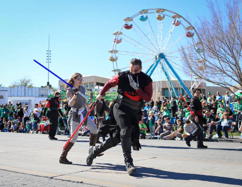 Two members of the Society of Light-saber Duelists UNLV chapter break into a fight during the 53rd Annual Southern Nevada Sons & Daughters of Erin St. Patrick's Day parade in Henderson, Nev., ...