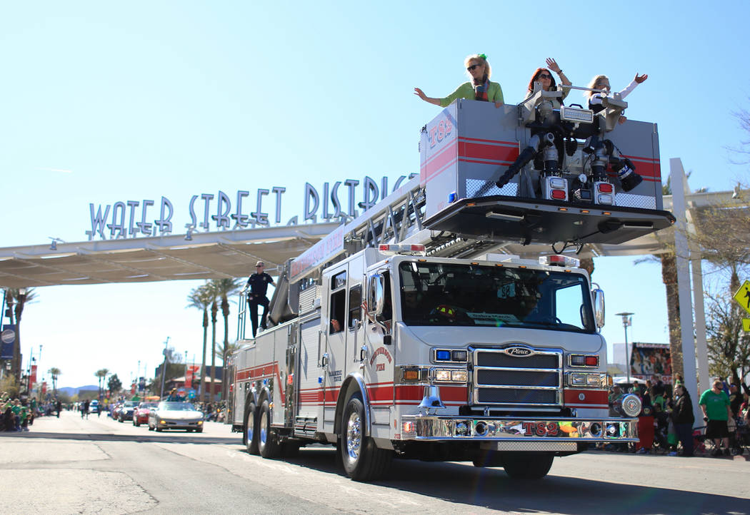 Henderson city mayor Debra March, middle in fire truck basket, waves to the crowd in the 53rd Annual Southern Nevada Sons & Daughters of Erin St. Patrick's Day parade in Henderson, Nev., on Sa ...