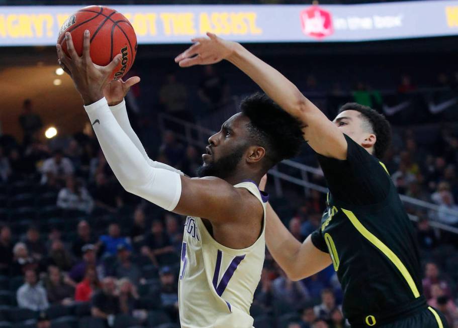 Washington's Jaylen Nowell shoots around Oregon's Will Richardson during the first half of an NCAA college basketball game in the final of the Pac-12 men's tournament Saturday, March 16, 2019, in ...