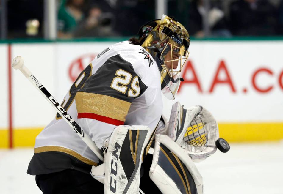 Vegas Golden Knights goaltender Marc-Andre Fleury (29) reaches out to glove a shot from the Dallas Stars in the first period of an NHL hockey game in Dallas, Friday, March 15, 2019. (AP Photo/Tony ...