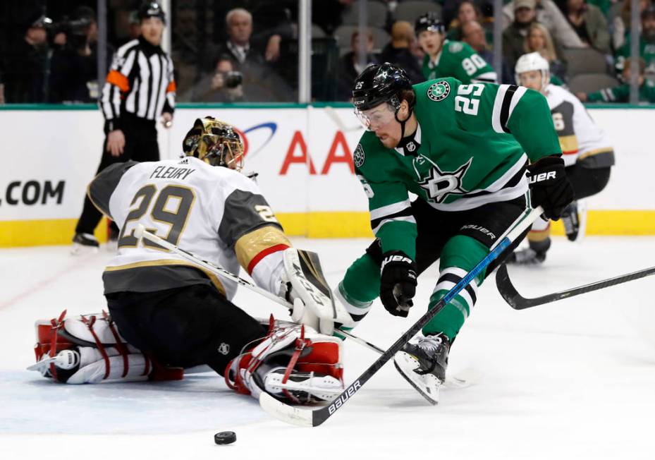 Vegas Golden Knights goaltender Marc-Andre Fleury (29) deflects a shot as Dallas Stars right wing Brett Ritchie (25) pressures the net in the first period of an NHL hockey game in Dallas, Friday, ...