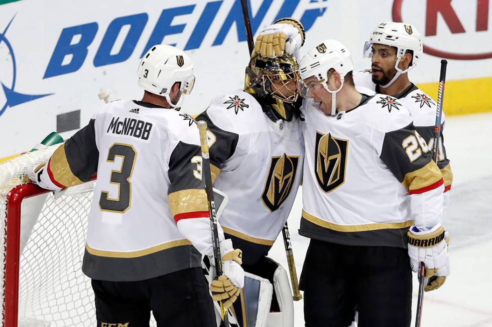 Vegas Golden Knights' Brayden McNabb (3), Paul Stastny (26) and Pierre-Edouard Bellemare, rear, celebrate with goalie Marc-Andre Fleury, second from left, after their 2-1 win against the Dallas St ...