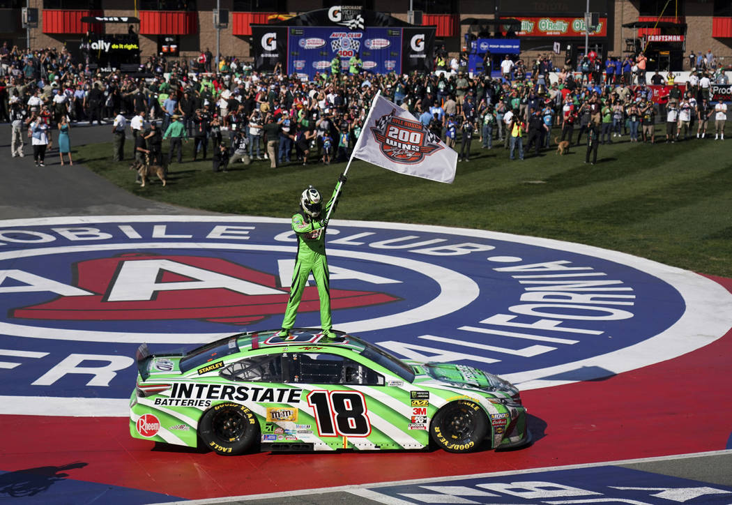 Kyle Buschs stands on his car after winning the NASCAR Cup Series race at Auto Club Speedway in Fontana, Calif., Sunday, March 17, 2019. (AP Photo/Rachel Luna)