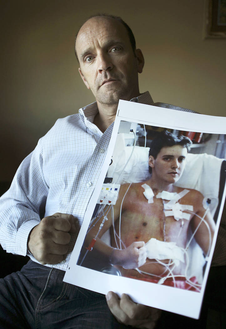 Former UNLV soccer star Simon Keith holds a photograph of himself while in his office on Wednesday, April 20, 2011, that was taken shortly after he underwent a heart transplant 25 years ago. (Las ...