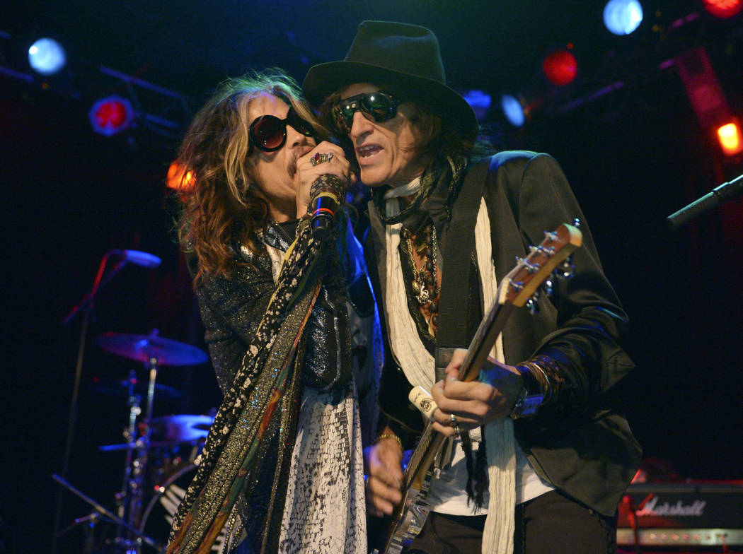 FILE - In this April 8, 2014 file photo, Steven Tyler, left, and Joe Perry of Aerosmith perform at the Whisky A Go Go in Los Angeles. Though others are canceling events and concerts after the ter ...