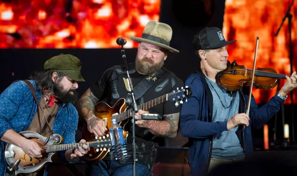 Coy Bowles, from left, Zac Brown and Jimmy De Martini of the Zac Brown Band perform at Fenway Park on Friday, June 15, 2018, in Boston. (Photo by Winslow Townson/Invision/AP)