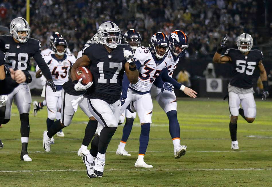 Oakland Raiders' Dwayne Harris (17) returns a punt for a touchdown against the Denver Broncos during the first half of an NFL football game in Oakland, Calif., Monday, Dec. 24, 2018. (AP Photo/D. ...