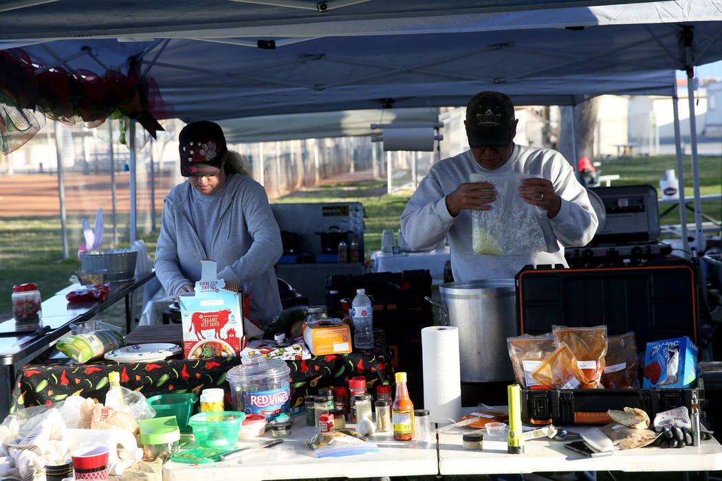 Husband and wife team of Connie and Brian Anthony of Laughlin prepare their competition chili and sample condoments at their booth at the Nevada State Chili Cook-off at Petrack Park in Pahrump Sun ...