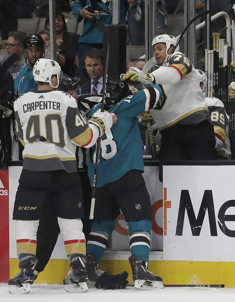 San Jose Sharks goaltender Aaron Dell, left, defends a shot attempt by Vegas Golden Knights center Jonathan Marchessault during the third period of an NHL hockey game in San Jose, Calif., Monday, ...