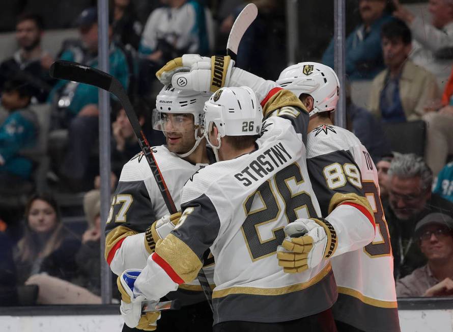 San Jose Sharks left wing Evander Kane, right, reaches for the puck next to Vegas Golden Knights defenseman Brayden McNabb during the third period of an NHL hockey game in San Jose, Calif., Monday ...