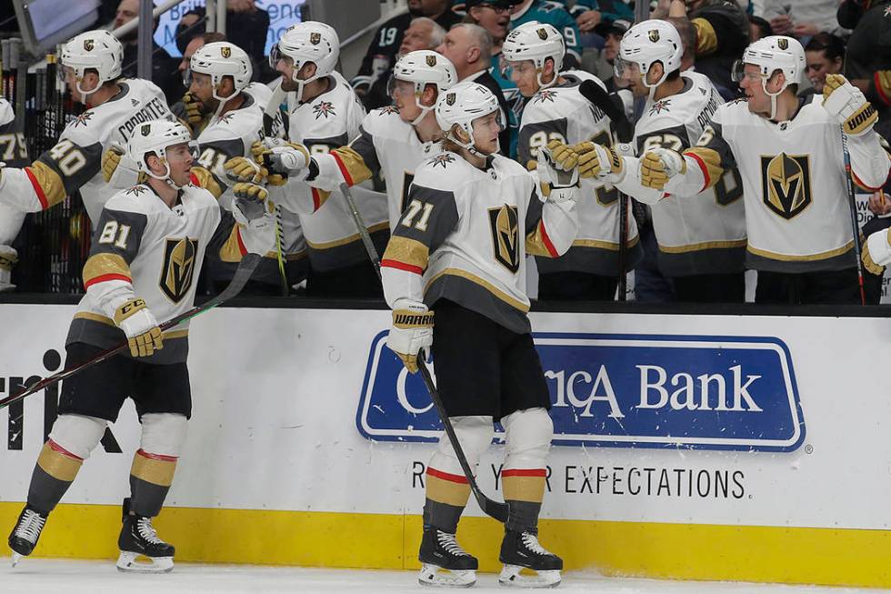 Vegas Golden Knights center William Karlsson (71) is congratulated by teammates after scoring a goal against the San Jose Sharks during the first period of an NHL hockey game in San Jose, Calif., ...