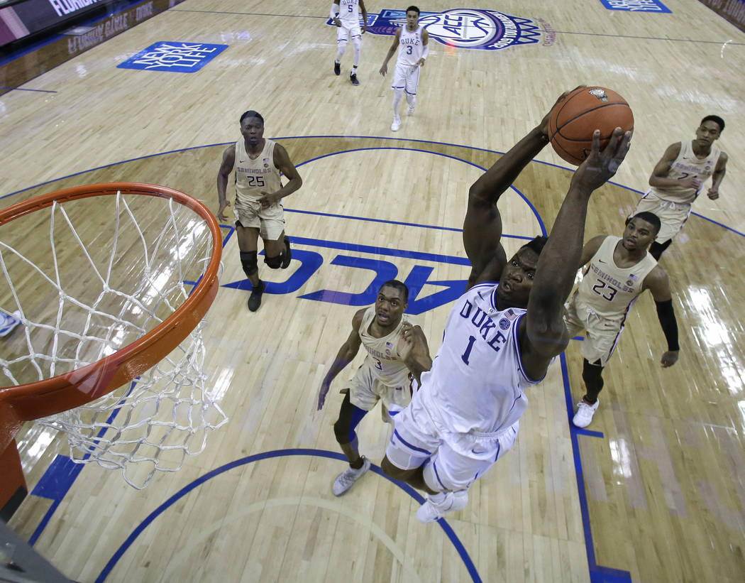 Duke's Zion Williamson (1) goes up to dunk against Florida State during the first half of the NCAA college basketball championship game of the Atlantic Coast Conference tournament in Charlotte, N. ...