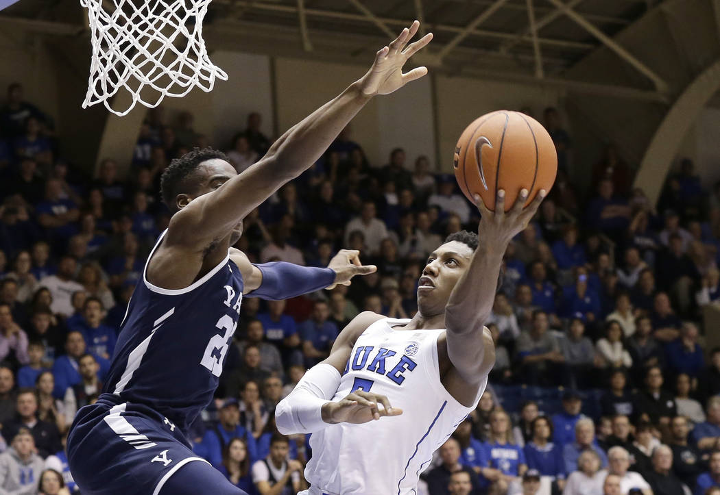 Duke's RJ Barrett shoots while Yale's Miye Oni defends during the second half of an NCAA college basketball game in Durham, N.C., Saturday, Dec. 8, 2018. Duke won 91-58. (AP Photo/Gerry Broome)