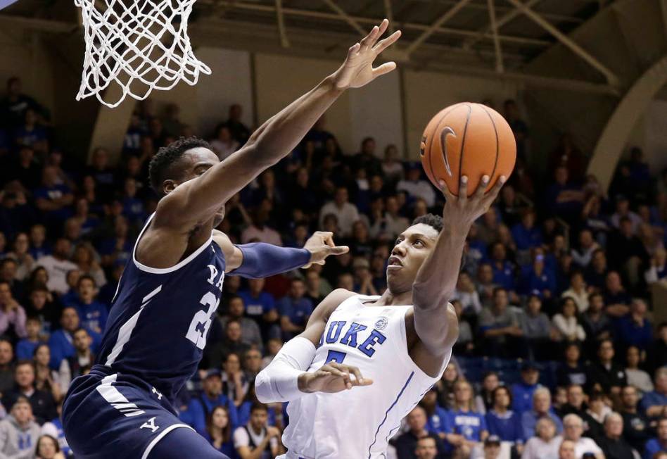 Duke's RJ Barrett shoots while Yale's Miye Oni defends during the second half of an NCAA college basketball game in Durham, N.C., Saturday, Dec. 8, 2018. Duke won 91-58. (AP Photo/Gerry Broome)
