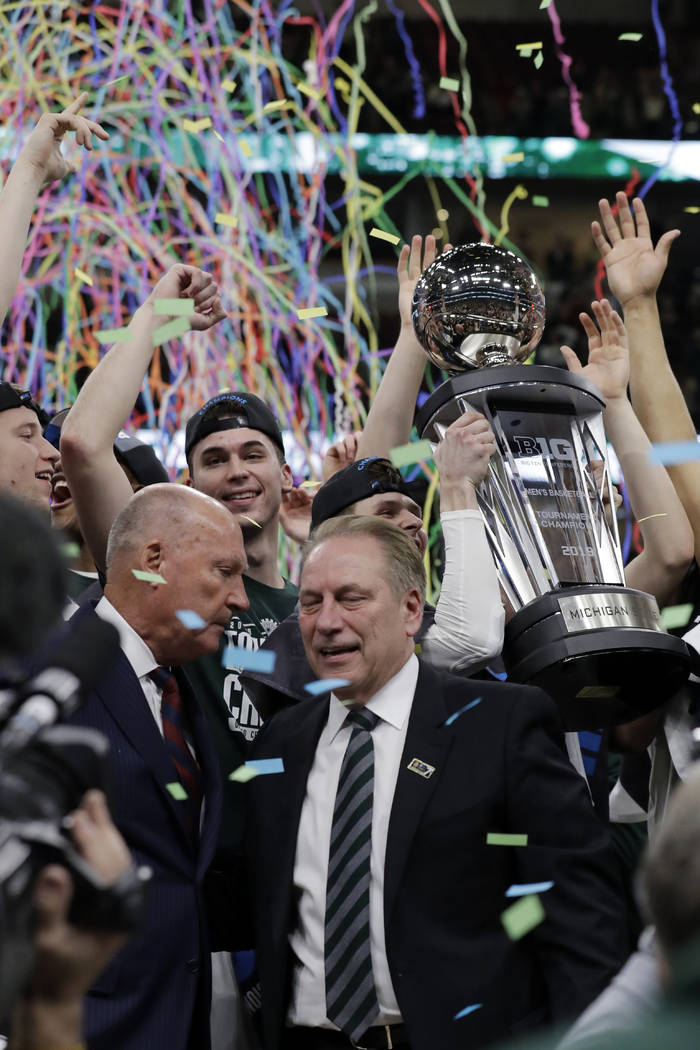Michigan State head coach Tom Izzo celebrates with his team after defeating Michigan 65-60 in an NCAA college basketball championship game in the Big Ten Conference tournament, Sunday, March 17, 2 ...
