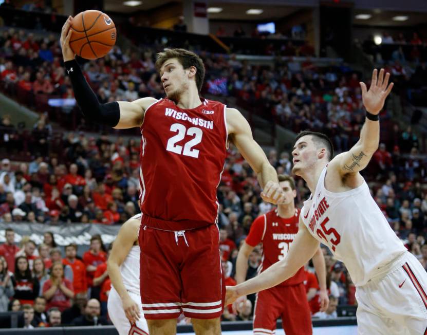 Wisconsin forward Ethan Happ, left, grabs a rebound against Ohio State forward Kyle Young during an NCAA college basketball game in Columbus, Ohio, Sunday, March 10, 2019. Wisconsin won 73-67 in o ...