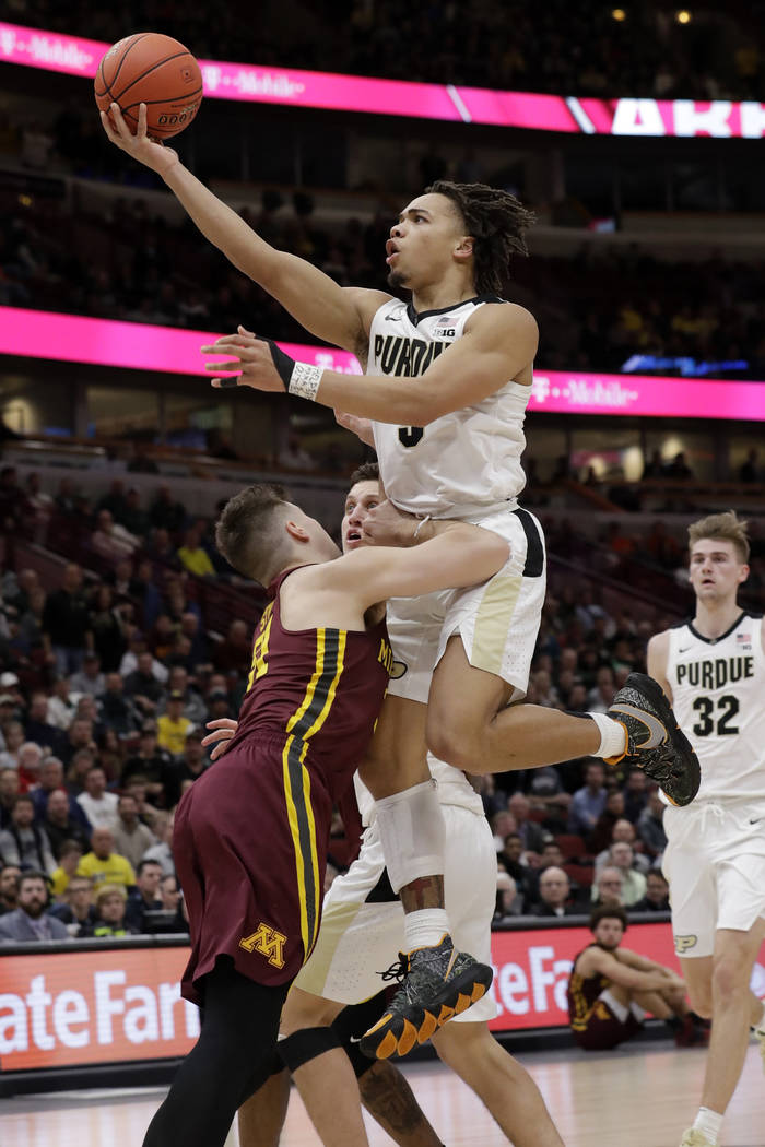 Purdue's Carsen Edwards goes up for a basket against Minnesota's Brock Stull during the second half of an NCAA college basketball game in the quarterfinals of the Big Ten Conference tournament, Fr ...