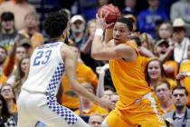 Tennessee's Grant Williams, right, protects the ball from Kentucky forward EJ Montgomery (23) in the first half of an NCAA college basketball game at the Southeastern Conference tournament Saturda ...
