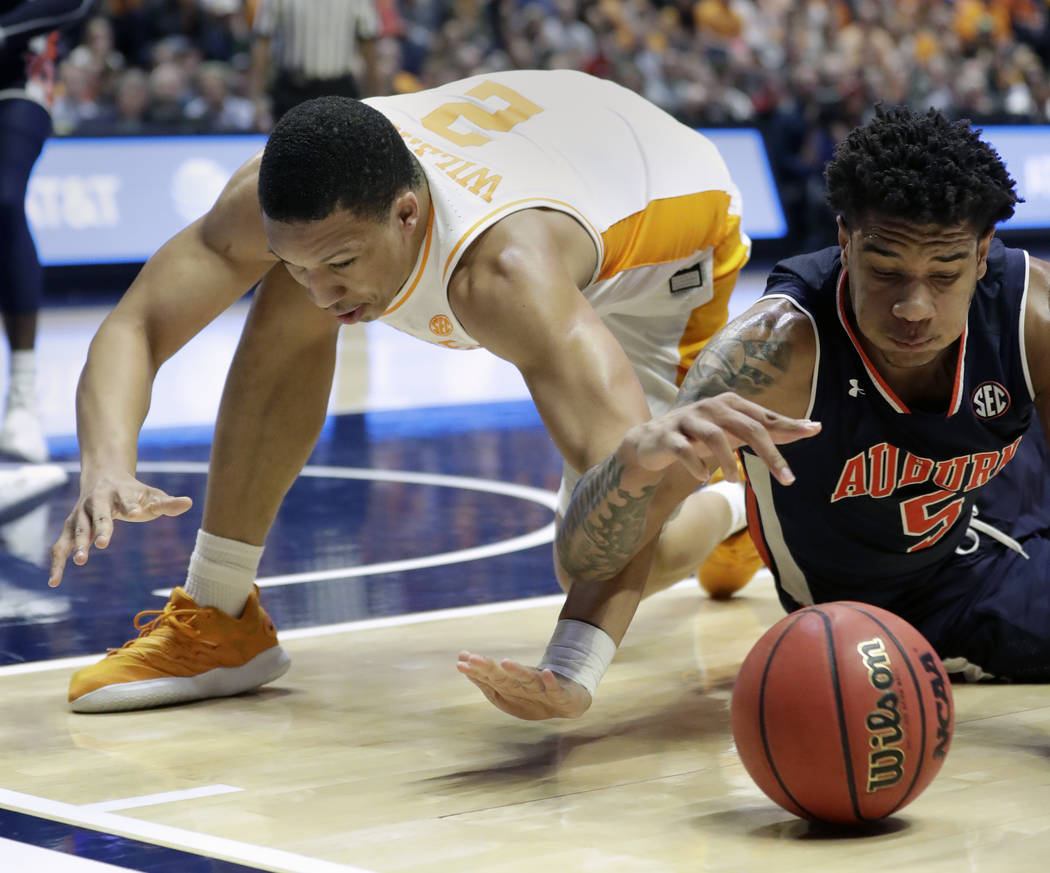 Tennessee's Grant Williams (2) and Auburn's Chuma Okeke (5) dive after a loose ball in the second half of the NCAA college basketball Southeastern Conference championship game Sunday, March 17, 20 ...