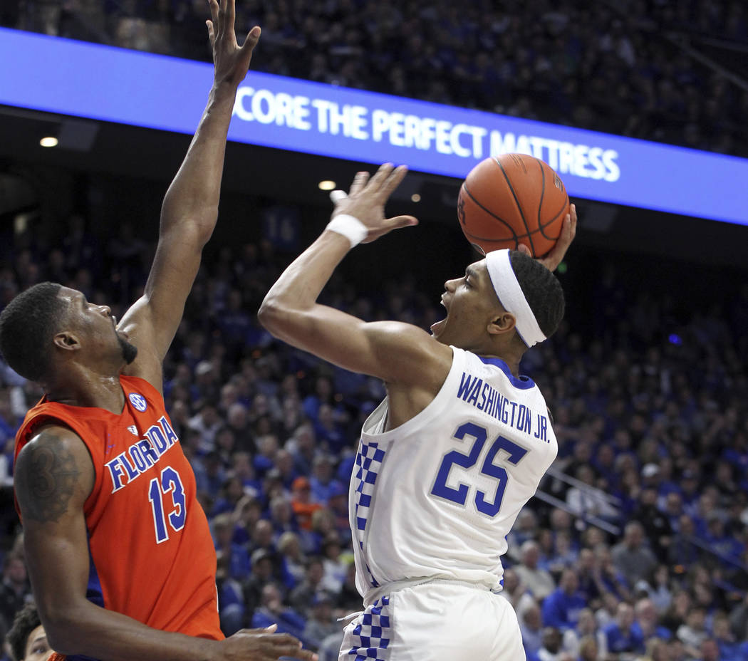 Kentucky's PJ Washington (25) shoots while pressured by Florida's Kevarrius Hayes (13) during the second half of an NCAA college basketball game in Lexington, Ky., Saturday, March 9, 2019. Kentuck ...
