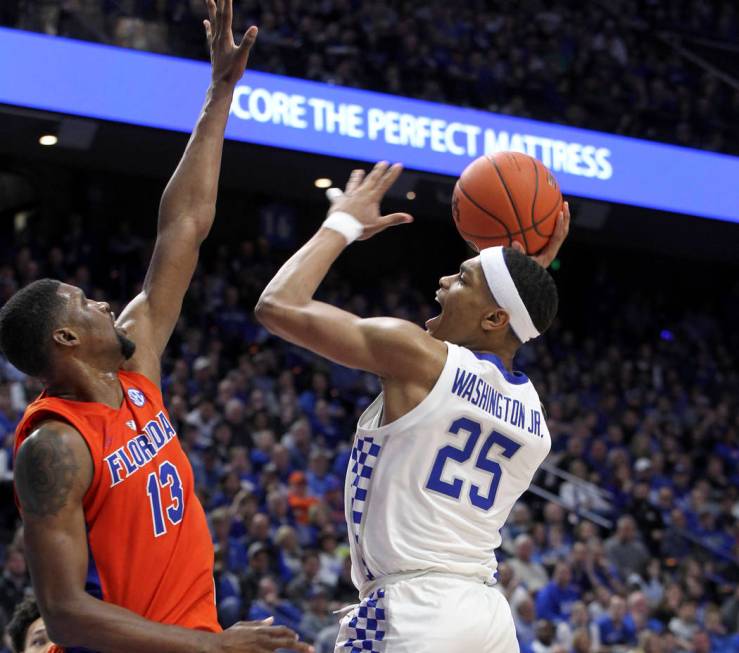 Kentucky's PJ Washington (25) shoots while pressured by Florida's Kevarrius Hayes (13) during the second half of an NCAA college basketball game in Lexington, Ky., Saturday, March 9, 2019. Kentuck ...