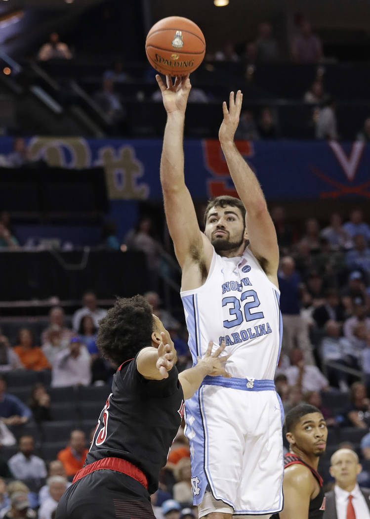 North Carolina's Luke Maye (32) shots over Louisville's Jordan Nwora (33) during the first half of an NCAA college basketball game in the Atlantic Coast Conference tournament in Charlotte, N.C., T ...
