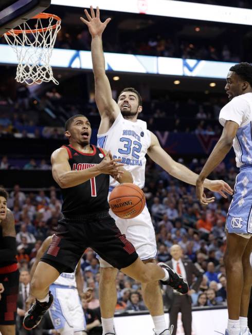 Louisville's Christen Cunningham (1) is fouled as he drives past North Carolina's Luke Maye (32) during the second half of an NCAA college basketball game in the Atlantic Coast Conference tourname ...