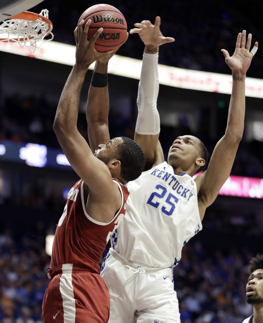 Alabama forward Galin Smith (30) shoots as he is defended by Kentucky forward PJ Washington (25) in the first half of an NCAA college basketball game at the Southeastern Conference tournament Frid ...