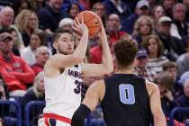 Gonzaga forward Killian Tillie, left, looks to pass in front of San Diego forward Isaiah Pineiro (0) during the second half of an NCAA college basketball game in Spokane, Wash., Saturday, Feb. 2, ...