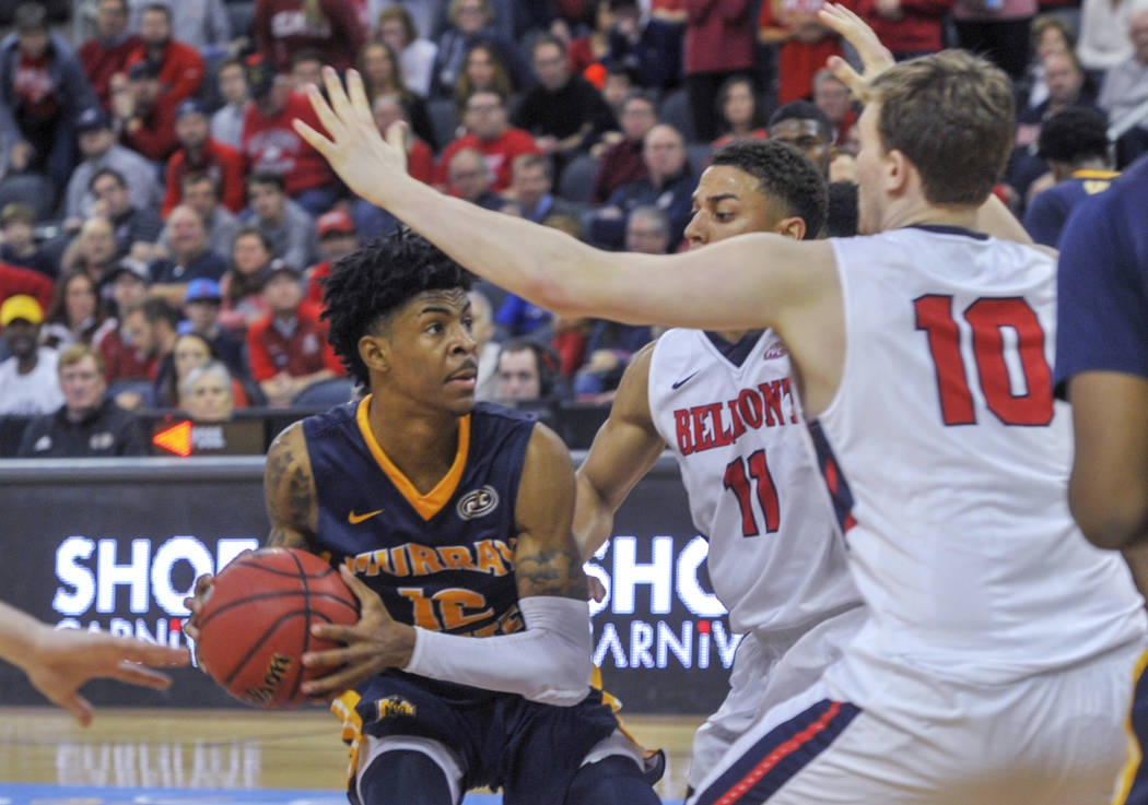 Murray State's Ja Morant (12) looks for an opening as Belmont's Kevin McClain (11) and Caleb Hollnder (10) defend during the second half of an NCAA college basketball game for the championship of ...