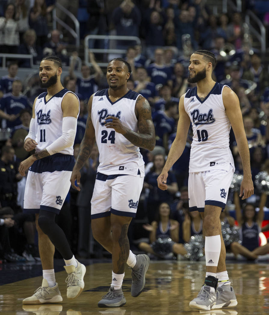 Nevada seniors Cody Martin (11), Jordan Caroline (24) and Caleb Martin (10) come off the floor at Lawlor Events Center for the last time at the end of their NCAA college basketball game against Sa ...