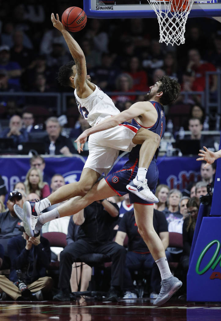 St. Mary's Jordan Hunter, right, fouls Gonzaga's Brandon Clarke during the second half of an NCAA college basketball game for the West Coast Conference men's tournament title Tuesday, March 12, 20 ...