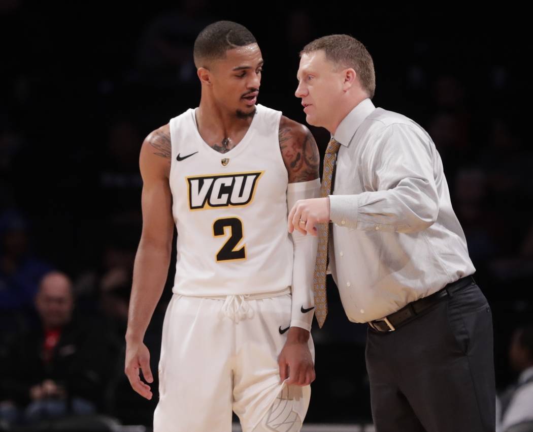 Virginia Commonwealth head coach Mike Rhoades, right, talks to Marcus Evans (2) during the first half of an NCAA college basketball game against Temple in the Legends Classic tournament Monday, No ...