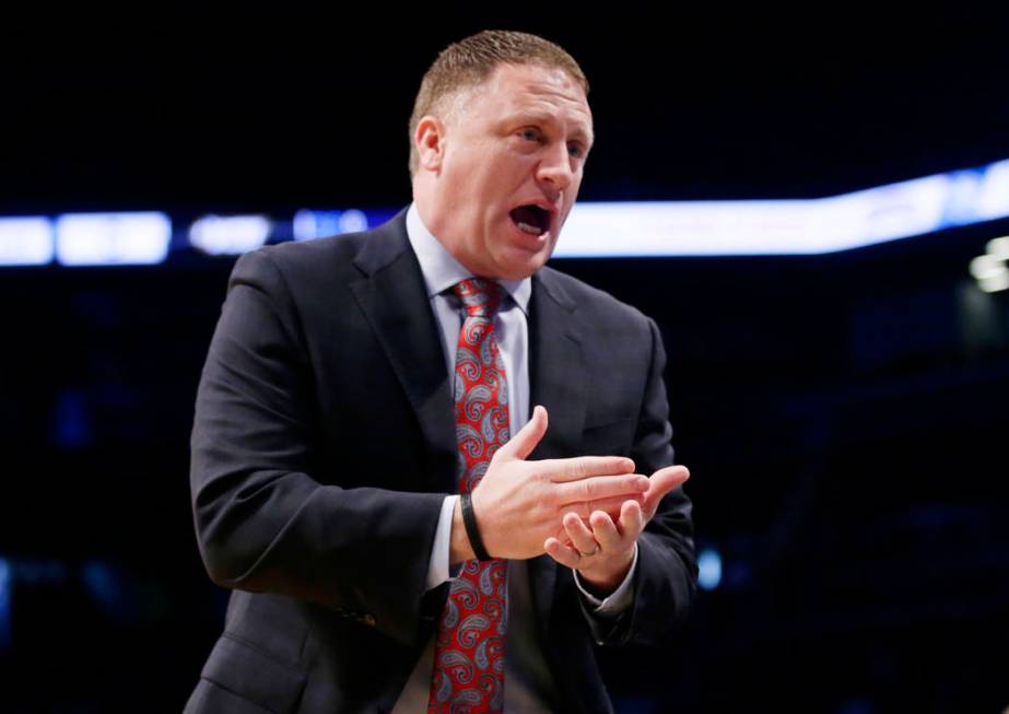 Virginia Commonwealth head coach Mike Rhoades talks to his team during the first half of an NCAA college basketball game against the St. John's in the championship round of the Legends Classic tou ...