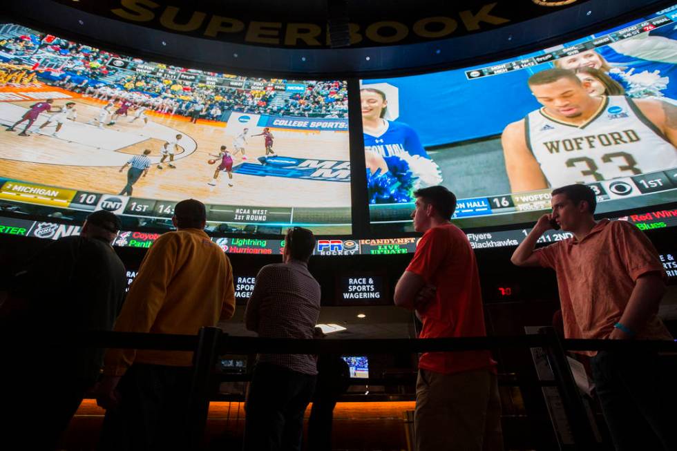 Basketball fans take in the first day of the NCAA Tournament at the Westgate Sportsbook on Thursday, March 21, 2019, at Westgate, in Las Vegas. (Benjamin Hager Review-Journal) @BenjaminHphoto