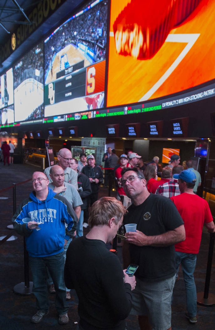 Basketball fans take in the first day of the NCAA Tournament at the Westgate Sportsbook on Thursday, March 21, 2019, at Westgate, in Las Vegas. (Benjamin Hager Review-Journal) @BenjaminHphoto