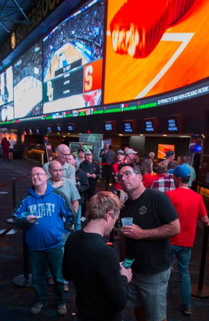 Basketball fans take in the first day of the NCAA Tournament at the Westgate Sportsbook on Thursday, March 21, 2019, at Westgate, in Las Vegas. (Benjamin Hager Review-Journal) @BenjaminHphoto