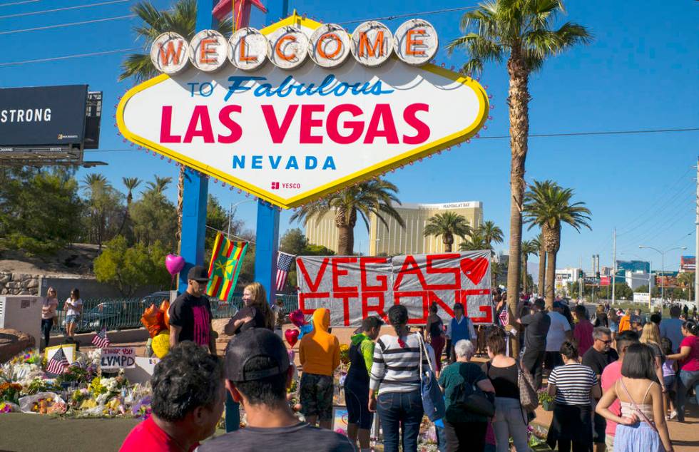 People visit a makeshift memorial for victims of the Oct. 1 mass shooting near the "Welcome to Fabulous Las Vegas" sign in Las Vegas on Saturday, Oct. 7, 2017. Chase Stevens Las Vegas Review-Journ ...