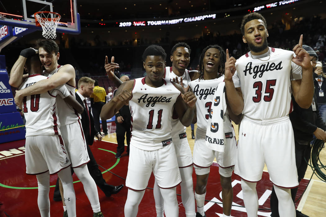 New Mexico State players celebrate after an 89-57 win over Grand Canyon in an NCAA college basketball game for the Western Athletic Conference men's tournament championship Saturday, March 16, 201 ...