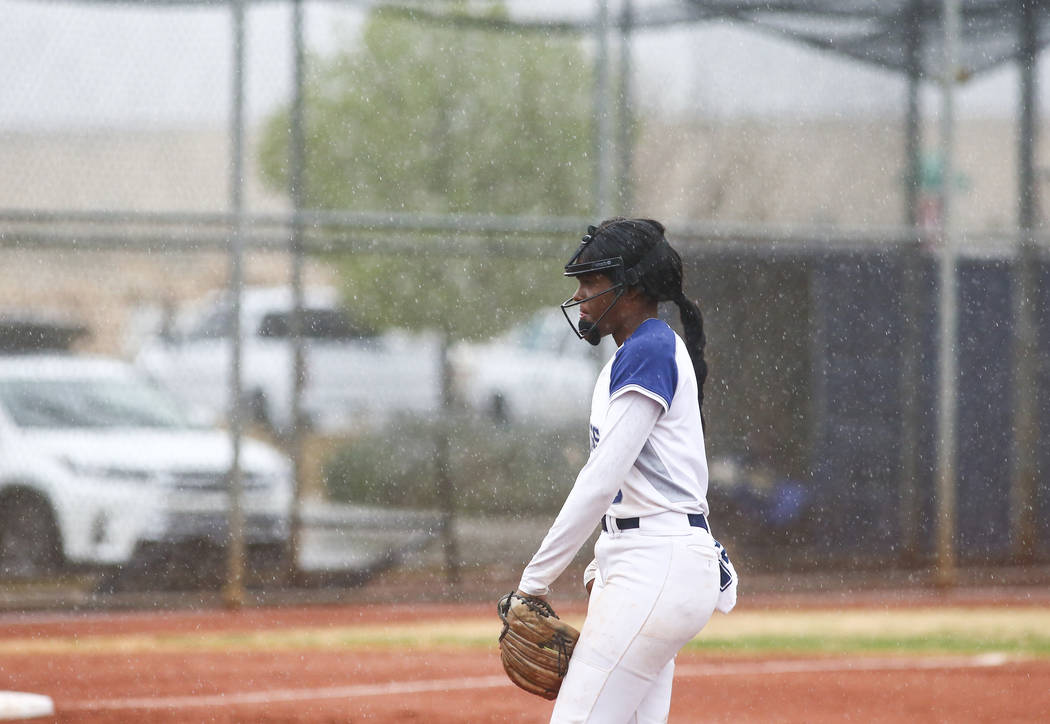 Shadow Ridge's Jasmine Martin (8) gets ready to pitch in the first inning of a softball game as rain pours down at Shadow Ridge High School in Las Vegas on Wednesday, March 20, 2019. (Chase Steven ...
