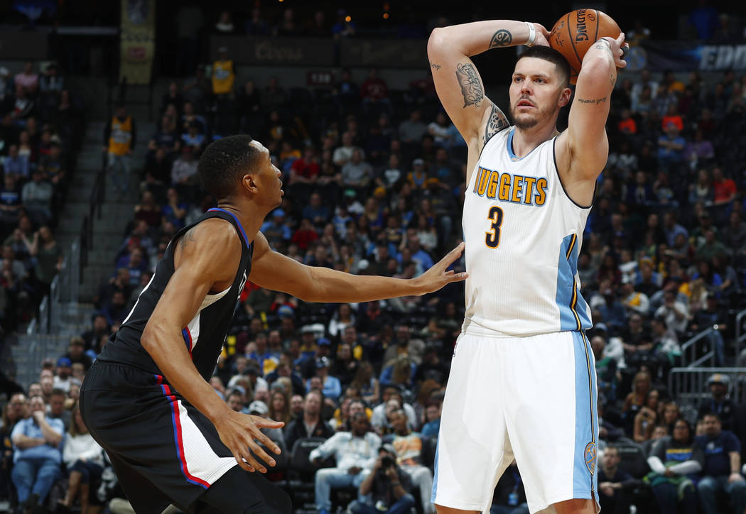 Los Angeles Clippers forward Wesley Johnson, left, defends as Denver Nuggets guard Mike Miller looks to pass the ball late in the second half of an NBA basketball game Saturday, Jan. 21, 2017, in ...