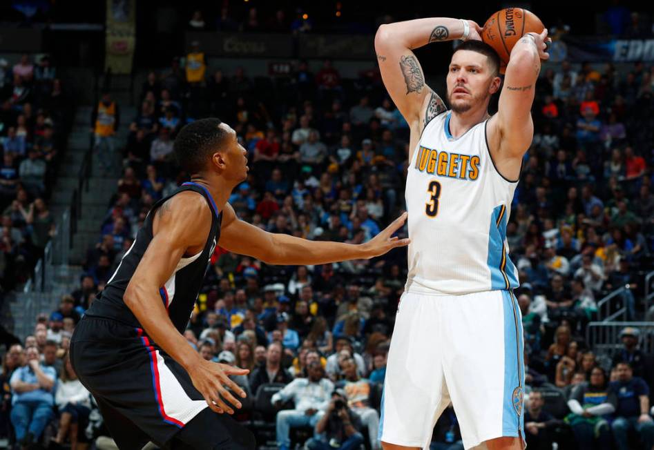 Los Angeles Clippers forward Wesley Johnson, left, defends as Denver Nuggets guard Mike Miller looks to pass the ball late in the second half of an NBA basketball game Saturday, Jan. 21, 2017, in ...