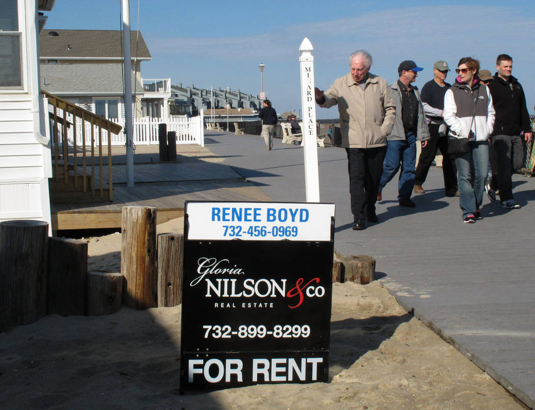 FILE- In this March 8, 2014 file photo people walk past a home being offered as a summer rental on the boardwalk in Point Pleasant Beach N.J. New Jersey shore property owners and renters worry tha ...