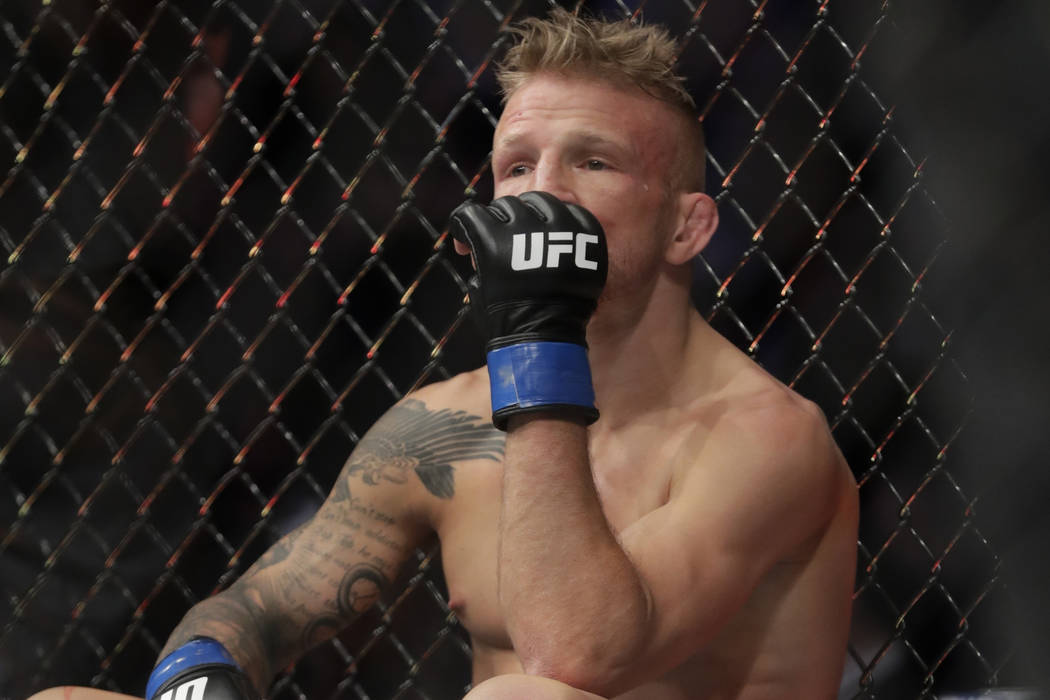FILE - In this Jan. 20, 2019 file photo, TJ Dillashaw reacts after a flyweight mixed martial arts championship bout against Henry Cejudo at UFC Fight Night in New York. Dillashaw has surrendered ...