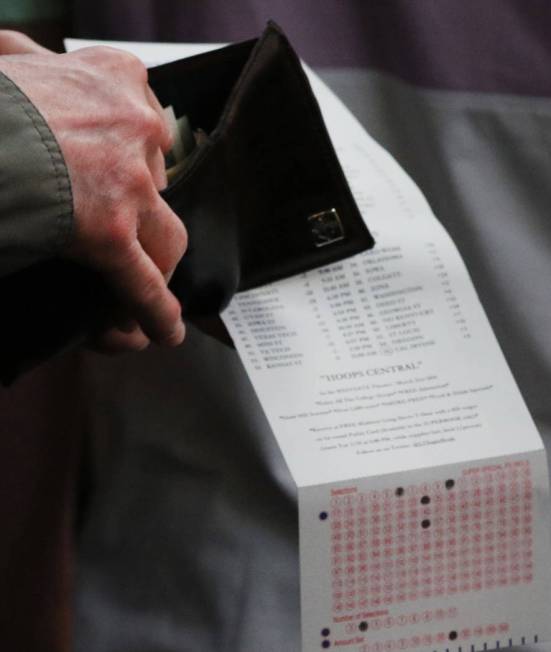 A fan prepares to place his bet during the first day of the NCAA basketball tournament at the Westgate sports book in Las Vegas on Thursday, March 16, 2019. (Bizuayehu Tesfaye Las Vegas Review-Jou ...