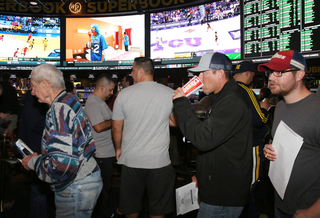 Fans lined up to place their bets during the first day of the NCAA basketball tournament at the Westgate sports book in Las Vegas on Thursday, March 16, 2019. (Bizuayehu Tesfaye Las Vegas Review-J ...