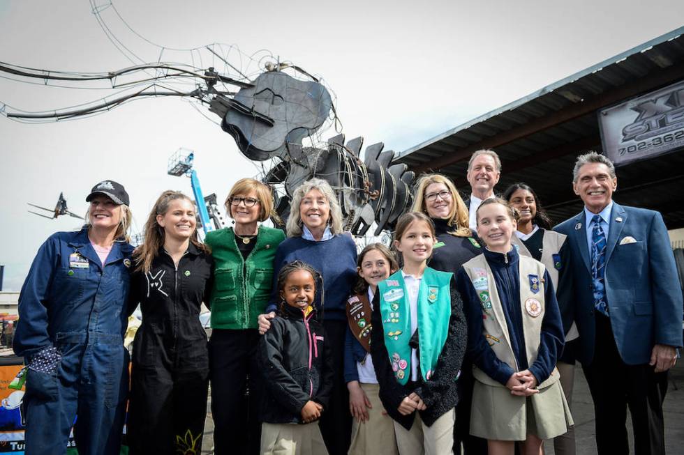 A group of elected officials, community leaders and volunteers pose for a photograph at a viewing of local Girl Scout Tahoe Mack's Monumental Mammoth structure at XL Steel in Las Vegas, Thursday, ...